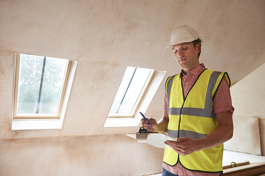 man holding a pen and a clip board